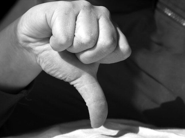 Black and white image of male giving thumbs down